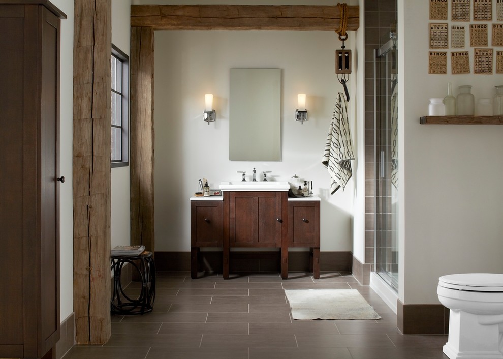 Example of a mid-sized arts and crafts master brown tile alcove shower design in Milwaukee with an integrated sink, shaker cabinets, dark wood cabinets, a one-piece toilet and beige walls