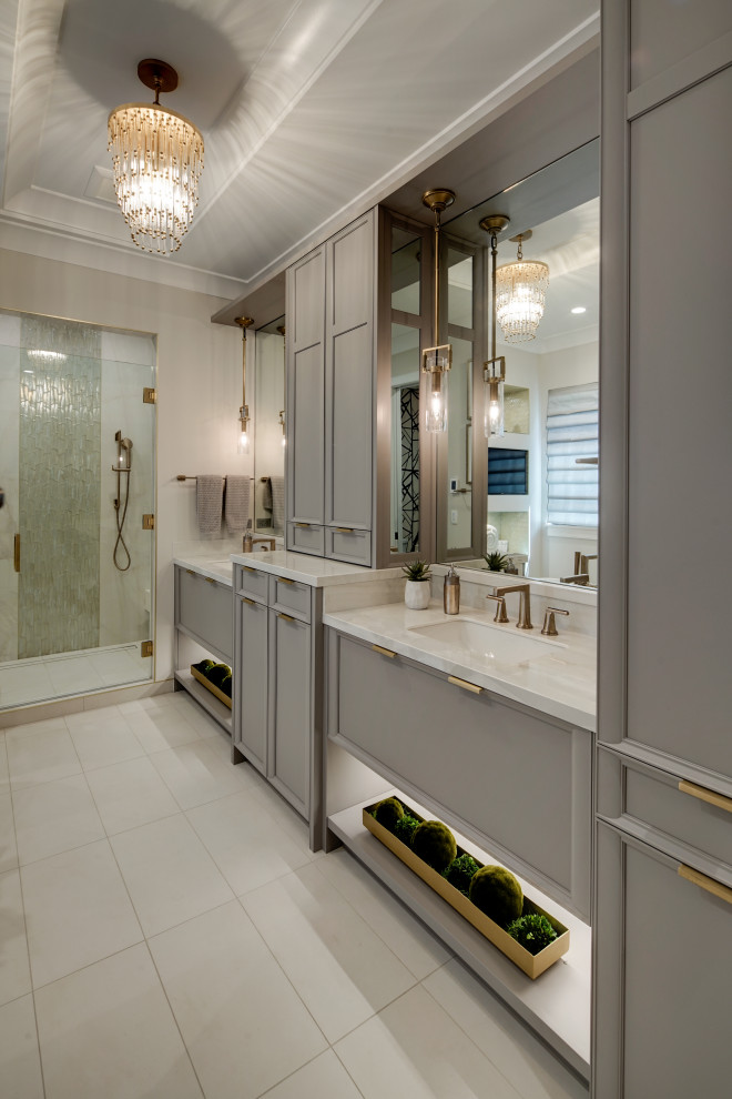 Inspiration for a traditional ensuite bathroom in Chicago with recessed-panel cabinets, grey cabinets, an alcove shower, beige walls, an integrated sink, beige floors, a hinged door, white worktops, double sinks, a built in vanity unit and a coffered ceiling.