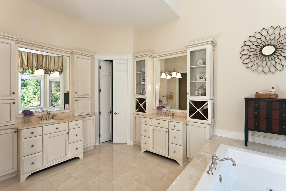 Large elegant master beige tile and marble tile marble floor and beige floor bathroom photo in Baltimore with recessed-panel cabinets, beige cabinets, an undermount tub, beige walls, an undermount sink and marble countertops