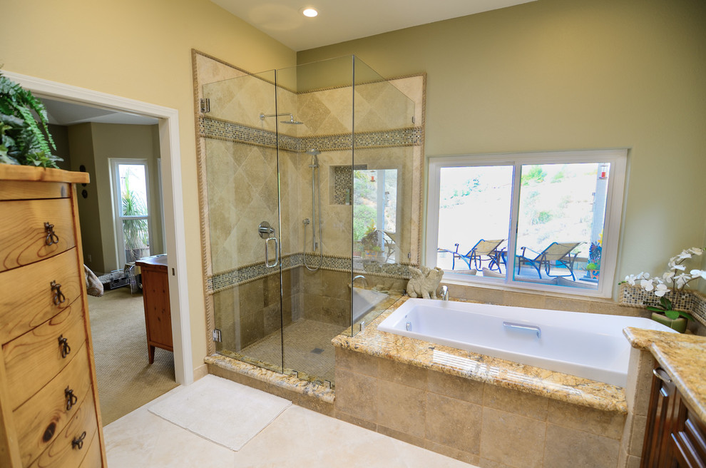 Bathroom - large traditional master brown tile and stone tile travertine floor bathroom idea in Tampa with an undermount sink, raised-panel cabinets, brown cabinets, granite countertops, a one-piece toilet and green walls