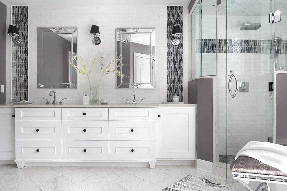 Example of a large transitional master white tile and glass tile porcelain tile and white floor bathroom design in New York with recessed-panel cabinets, white cabinets, a one-piece toilet, purple walls, an undermount sink, quartz countertops, a hinged shower door and white countertops