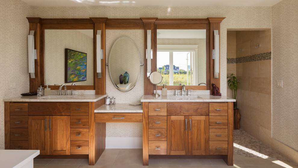 Large classic ensuite bathroom in Milwaukee with freestanding cabinets, medium wood cabinets, beige tiles, a freestanding bath, a built-in shower, beige walls, a submerged sink, engineered stone worktops, porcelain tiles, porcelain flooring, beige floors and white worktops.