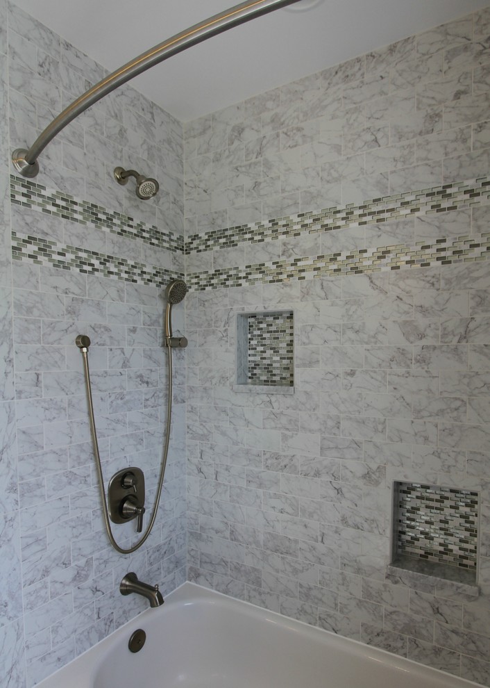 Design ideas for a medium sized traditional ensuite bathroom in Baltimore with recessed-panel cabinets, white cabinets, an alcove bath, a shower/bath combination, a two-piece toilet, grey tiles, multi-coloured tiles, white tiles, stone tiles, green walls, marble flooring, a submerged sink, marble worktops, grey floors, white worktops, a wall niche, double sinks and a built in vanity unit.