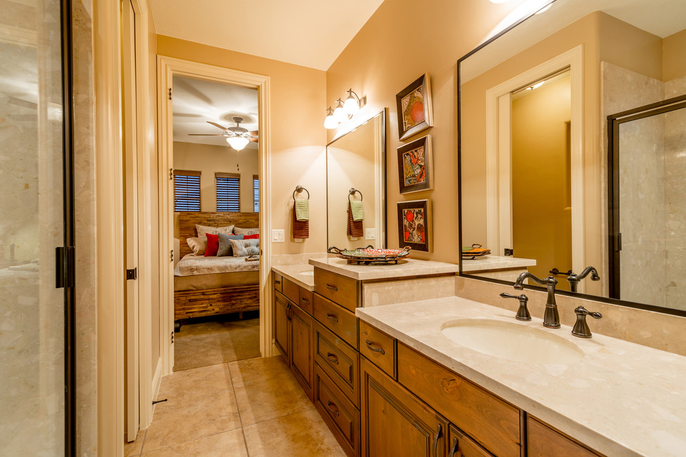 Design ideas for a large classic ensuite bathroom in Salt Lake City with raised-panel cabinets, medium wood cabinets, an alcove shower, engineered stone worktops, beige walls, ceramic flooring and a submerged sink.