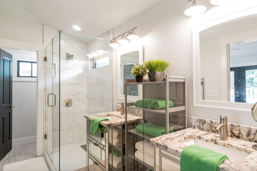 Corner shower - mid-sized craftsman master ceramic tile and gray floor corner shower idea in Other with glass-front cabinets, gray cabinets, a two-piece toilet, white walls, a console sink, marble countertops, a hinged shower door and multicolored countertops