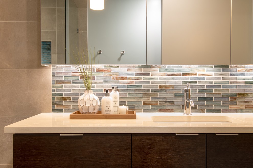 This is an example of a medium sized contemporary ensuite bathroom in Seattle with flat-panel cabinets, dark wood cabinets, engineered stone worktops and multi-coloured tiles.
