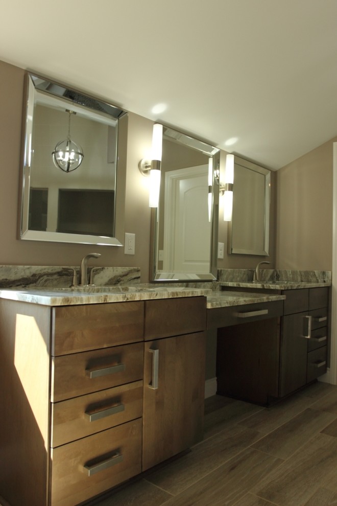 This is an example of a medium sized contemporary ensuite bathroom in Detroit with flat-panel cabinets, grey cabinets, a freestanding bath, white tiles, porcelain tiles and granite worktops.