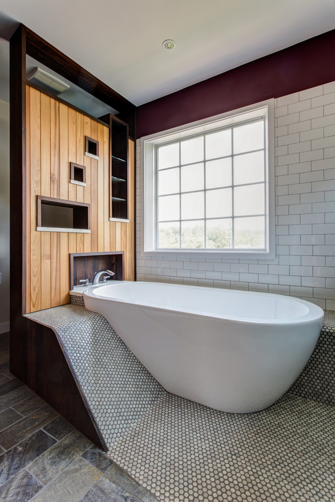This is an example of a contemporary ensuite bathroom in Other with open cabinets, medium wood cabinets, a freestanding bath, white tiles and metro tiles.