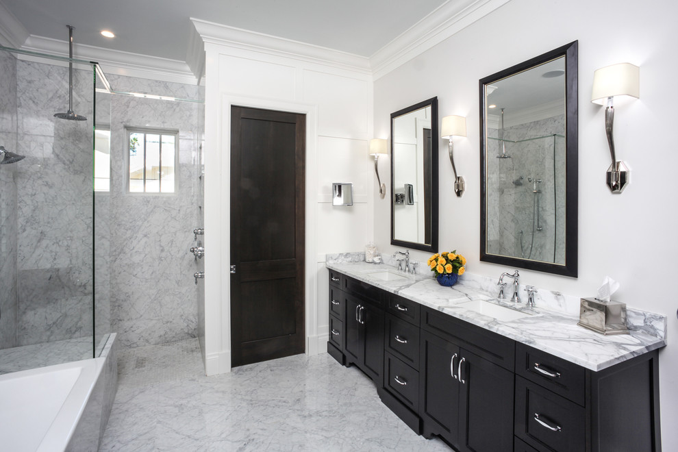 Large transitional master white tile and stone slab marble floor and white floor bathroom photo in Tampa with shaker cabinets, black cabinets, beige walls, an undermount sink, quartzite countertops, a hinged shower door and white countertops