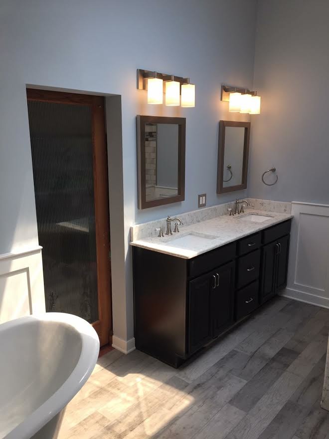 Example of a large transitional master gray tile and porcelain tile painted wood floor bathroom design in Other with shaker cabinets, dark wood cabinets, marble countertops, a one-piece toilet, blue walls and an undermount sink