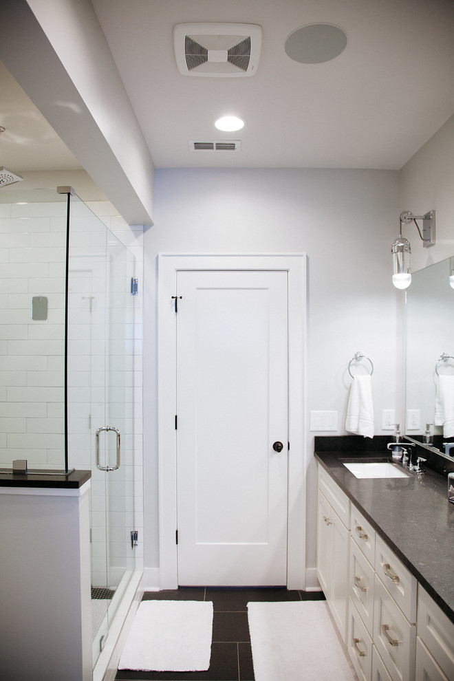 Photo of a contemporary ensuite bathroom in Nashville with recessed-panel cabinets, white cabinets, a walk-in shower, white walls, porcelain flooring, a built-in sink, granite worktops, black floors and an open shower.