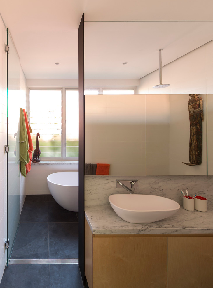 Contemporary bathroom in Sydney with a vessel sink, flat-panel cabinets, light wood cabinets, a freestanding bath and a built-in shower.