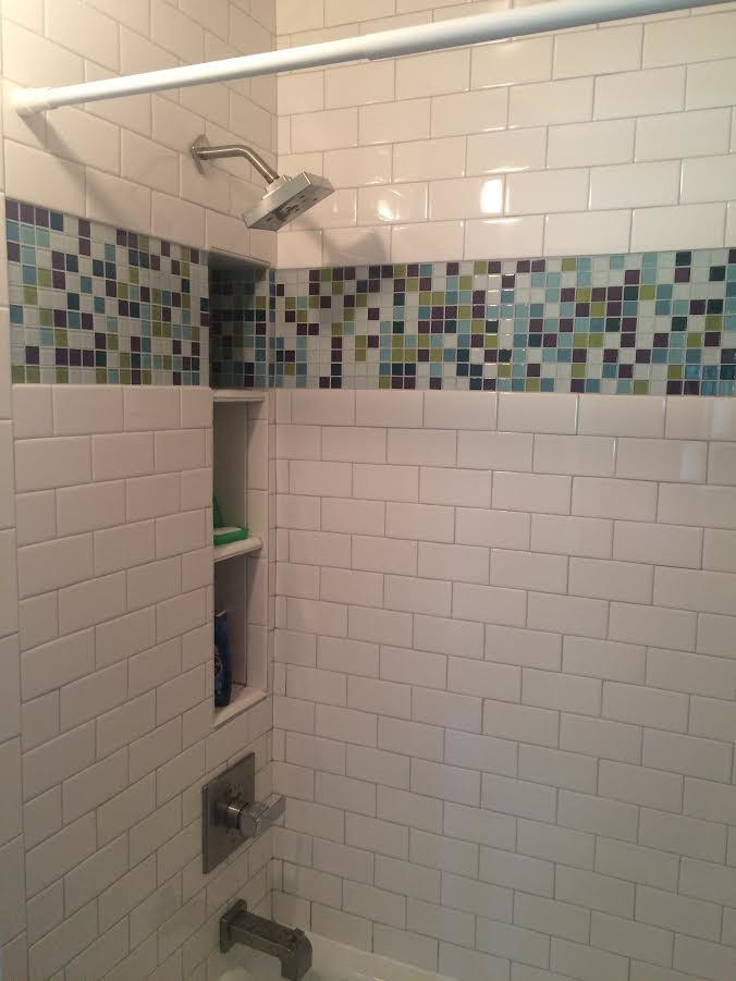 Photo of a small contemporary family bathroom in Salt Lake City with an alcove bath, a shower/bath combination, multi-coloured tiles, glass tiles and white walls.