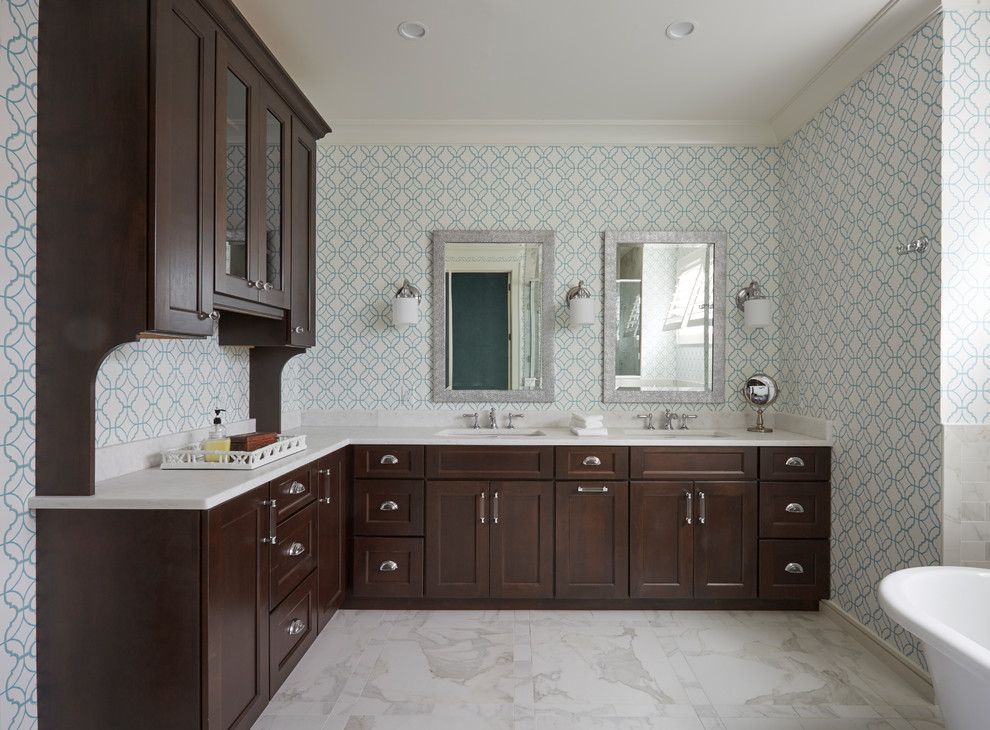 Inspiration for a large coastal master white tile and porcelain tile porcelain tile and white floor bathroom remodel in Jacksonville with recessed-panel cabinets, dark wood cabinets, a one-piece toilet, blue walls, an undermount sink, marble countertops and a hinged shower door