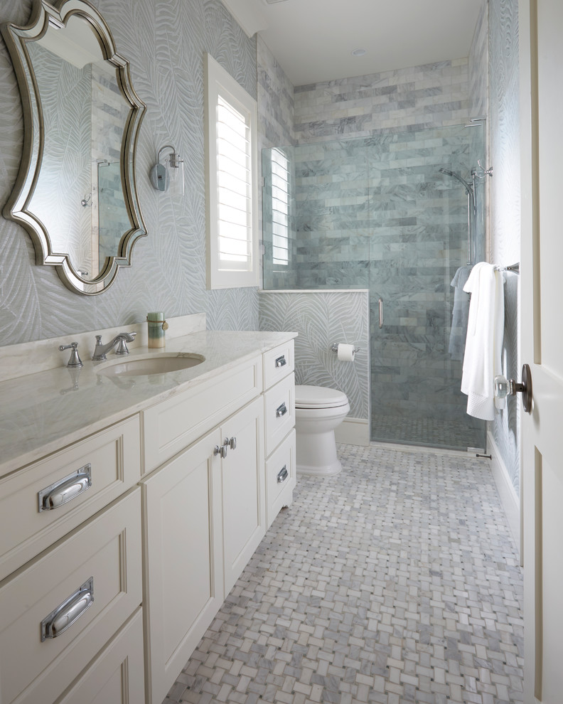 Inspiration for a large beach style family bathroom in Jacksonville with recessed-panel cabinets, white cabinets, an alcove shower, a one-piece toilet, white tiles, porcelain tiles, grey walls, marble flooring, a submerged sink, marble worktops, white floors and a hinged door.