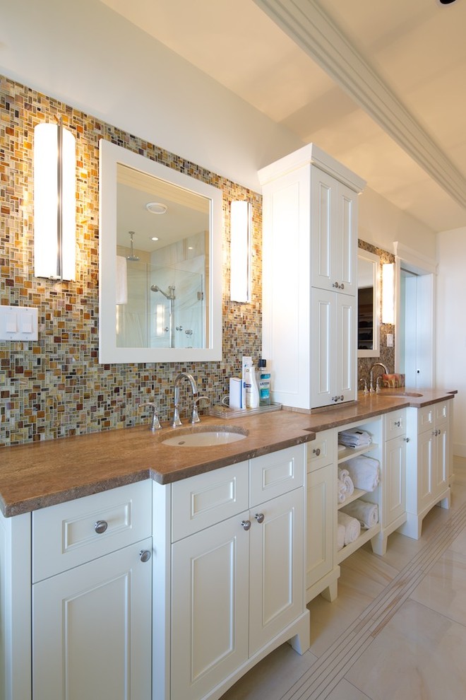 Large classic ensuite bathroom in Vancouver with flat-panel cabinets, white cabinets, a submerged sink, mosaic tiles, multi-coloured tiles and white walls.