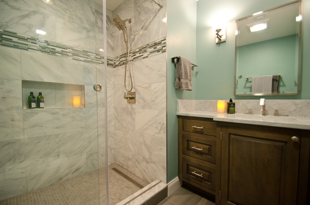 Exempel på ett litet amerikanskt en-suite badrum, med luckor med profilerade fronter, grå skåp, en dusch i en alkov, en toalettstol med separat cisternkåpa, vit kakel, marmorkakel, blå väggar, klinkergolv i porslin, ett undermonterad handfat, marmorbänkskiva, grått golv och dusch med skjutdörr