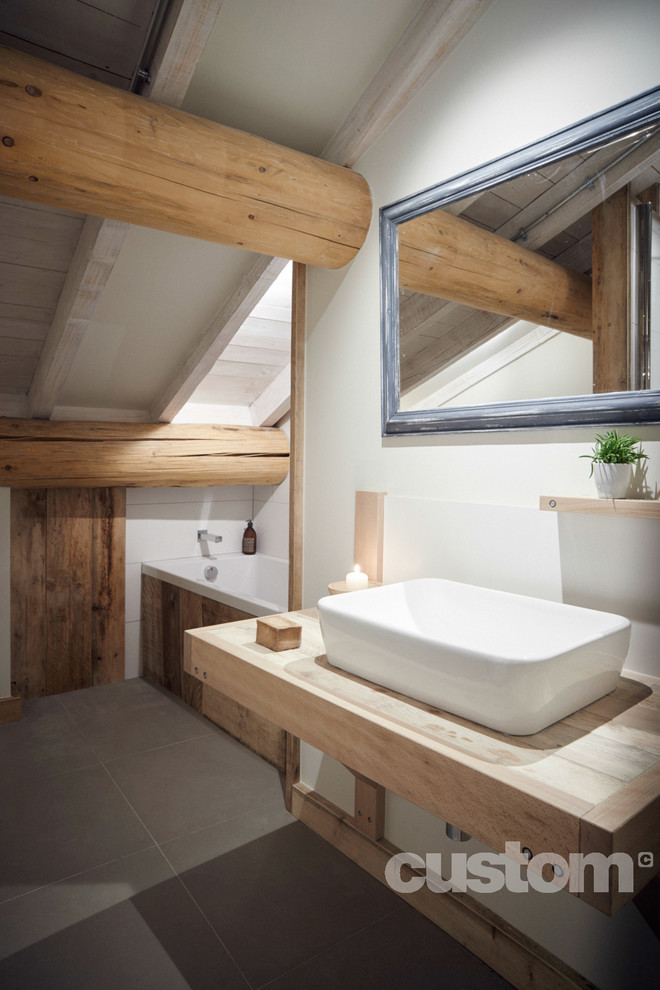 Inspiration for a mid-sized industrial master bathroom remodel in Grenoble with light wood cabinets, a wall-mount toilet, white walls and a vessel sink