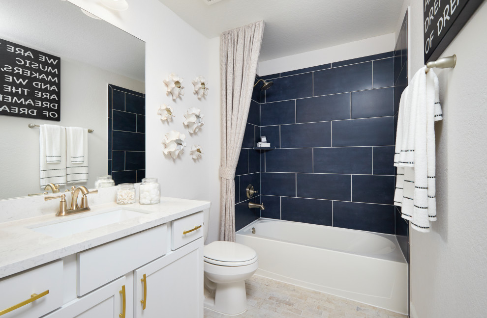Example of a mid-sized trendy kids' blue tile and ceramic tile ceramic tile, beige floor and single-sink bathroom design in Other with recessed-panel cabinets, white cabinets, white walls, an undermount sink, marble countertops and white countertops