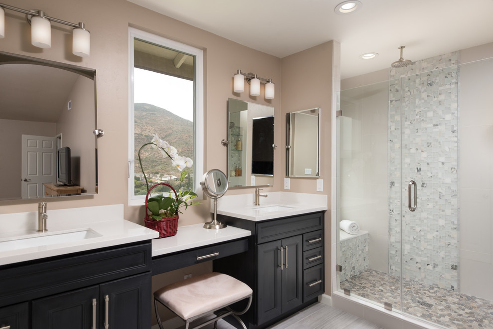 Example of a mid-sized transitional master multicolored tile and glass tile light wood floor alcove shower design in San Diego with shaker cabinets, black cabinets, a one-piece toilet, beige walls, an integrated sink and marble countertops