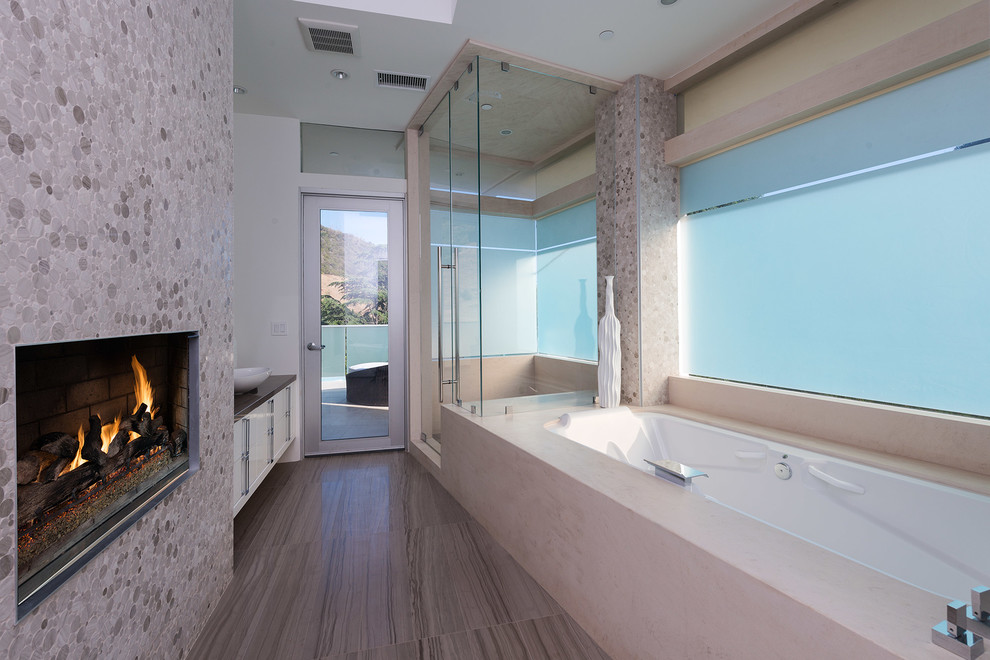 Réalisation d'une salle de bain design avec une baignoire encastrée, une douche d'angle et un carrelage beige.