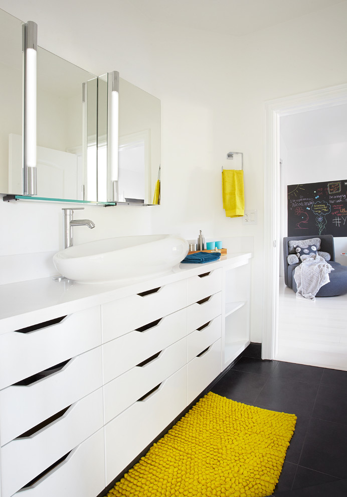 Design ideas for a contemporary grey and yellow family bathroom in Orange County with a vessel sink, flat-panel cabinets, white cabinets, white walls, porcelain flooring, solid surface worktops, black floors and white worktops.