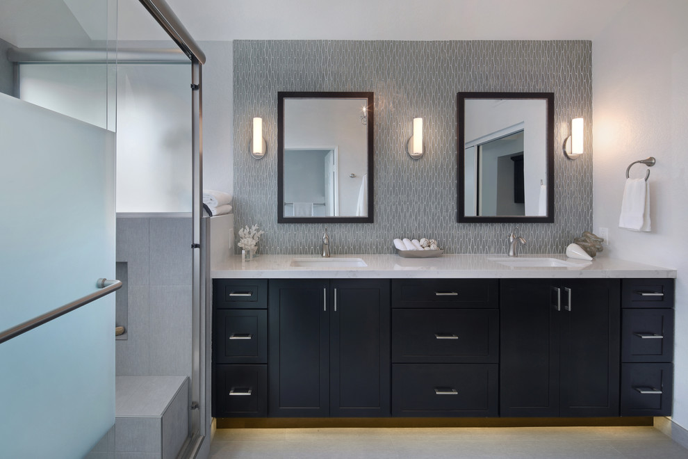 Design ideas for a medium sized classic ensuite bathroom in Orange County with shaker cabinets, dark wood cabinets, an alcove shower, a one-piece toilet, grey tiles, glass tiles, grey walls, porcelain flooring, a submerged sink, engineered stone worktops, grey floors and a sliding door.