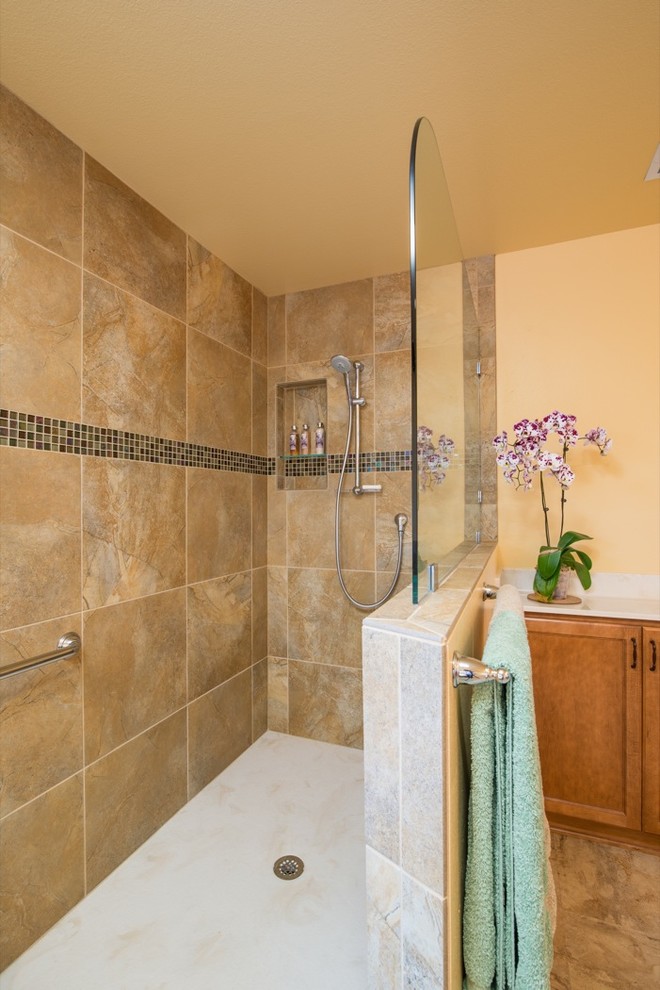 Inspiration for a large world-inspired ensuite bathroom in San Diego with flat-panel cabinets, light wood cabinets, a built-in bath, an alcove shower, brown tiles, glass tiles, yellow walls, lino flooring, an integrated sink and marble worktops.