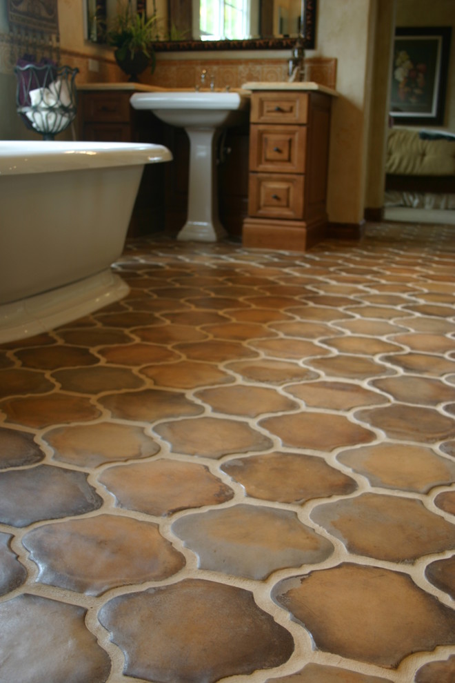 Inspiration for a mediterranean bathroom in Los Angeles with a freestanding bath and terracotta flooring.