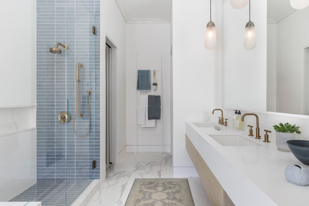 Large modern ensuite bathroom in San Francisco with flat-panel cabinets, light wood cabinets, a submerged bath, a corner shower, grey tiles, metro tiles, white walls, marble flooring, a submerged sink, engineered stone worktops, multi-coloured floors and a hinged door.