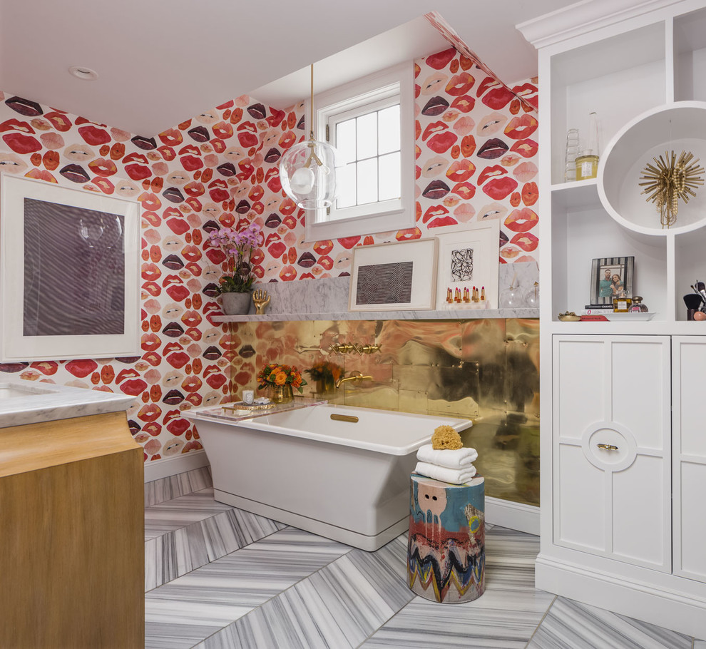 This is an example of a bohemian bathroom in San Francisco with white cabinets, a freestanding bath, red walls, marble flooring and recessed-panel cabinets.