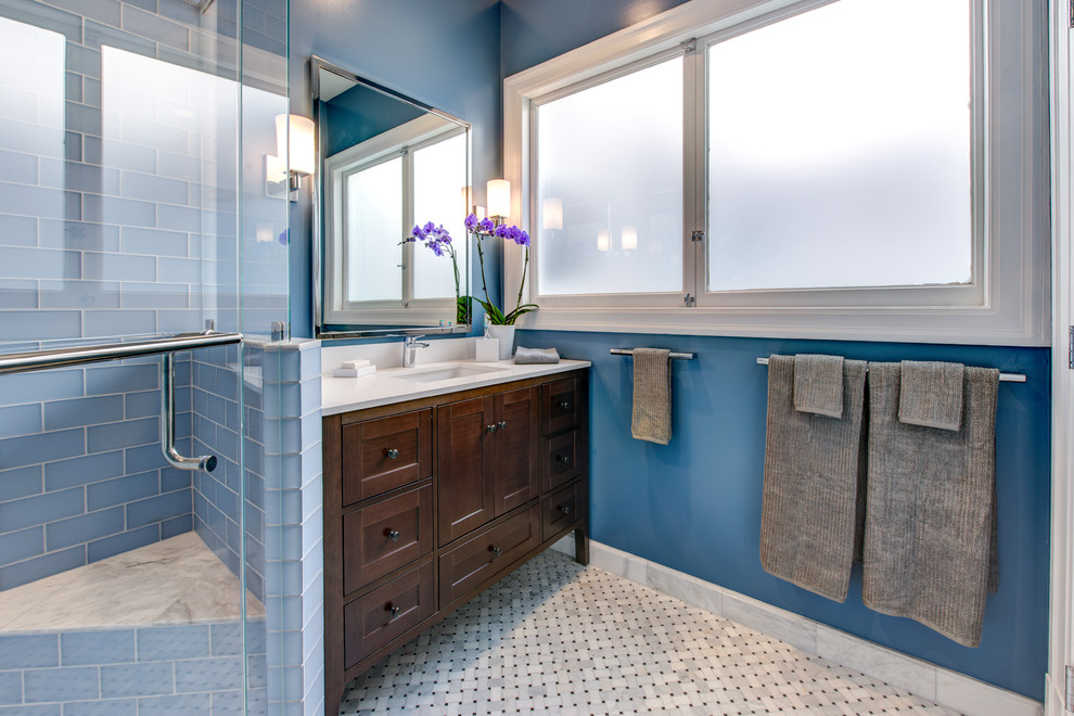 Photo of a medium sized traditional shower room bathroom in San Francisco with a submerged sink, freestanding cabinets, dark wood cabinets, a corner shower, blue tiles, glass tiles, blue walls, mosaic tile flooring, grey floors, a hinged door, white worktops, a laundry area, a shower bench, a single sink and a built in vanity unit.