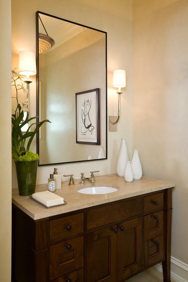 Mid-sized elegant 3/4 beige tile and stone slab limestone floor bathroom photo in San Francisco with a vessel sink, recessed-panel cabinets, dark wood cabinets, limestone countertops, a one-piece toilet and beige walls