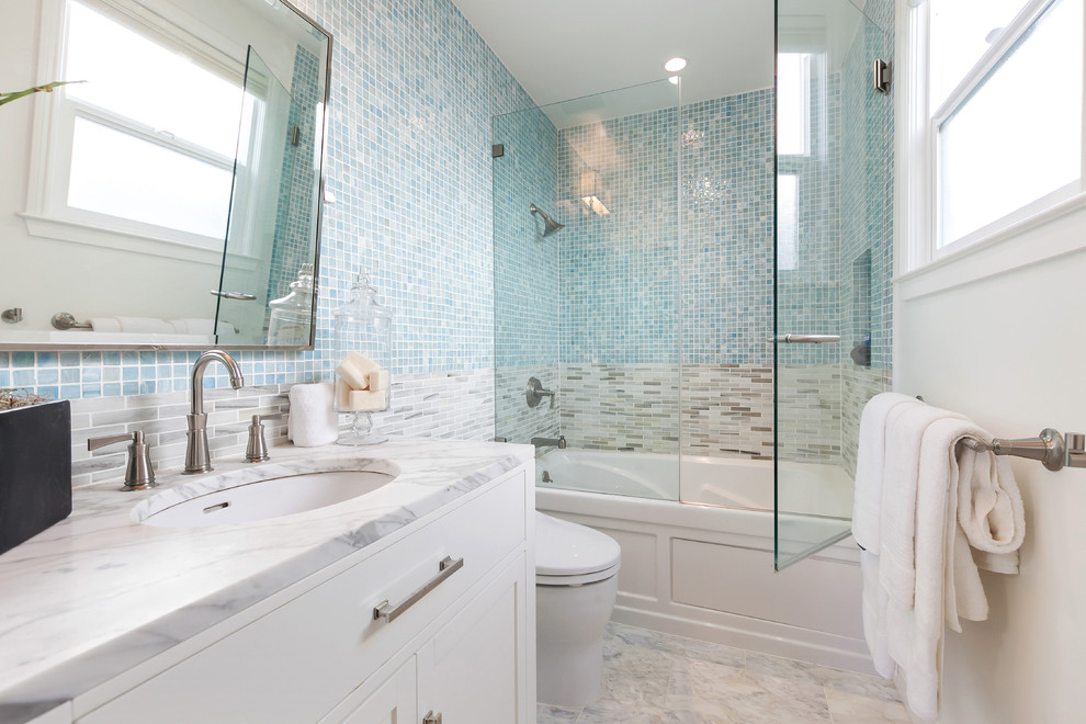 Design ideas for a medium sized ensuite bathroom in San Francisco with beaded cabinets, white cabinets, an alcove bath, an alcove shower, a one-piece toilet, multi-coloured tiles, grey walls, limestone flooring, a submerged sink and marble worktops.