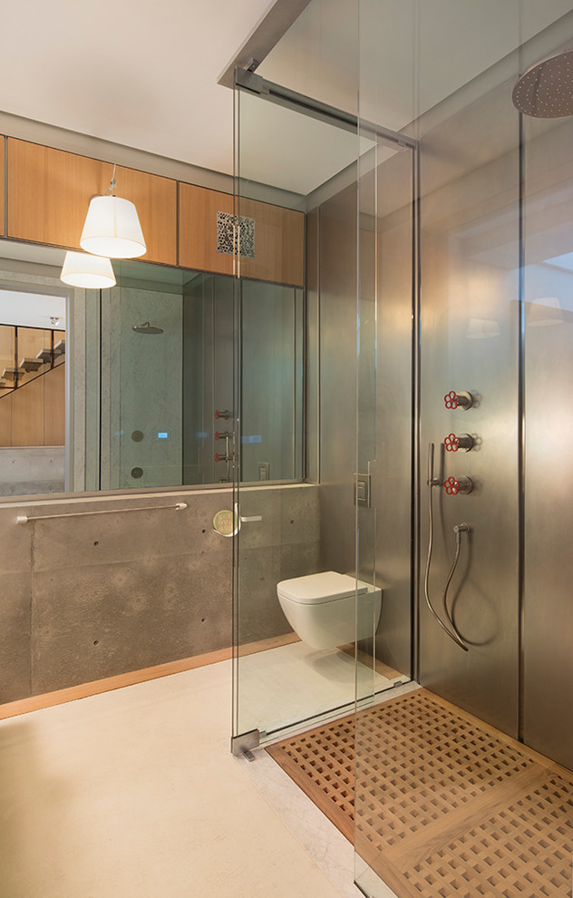 Photo of an urban bathroom in San Francisco with a built-in shower, a wall mounted toilet, metal tiles, grey walls, white floors and an open shower.