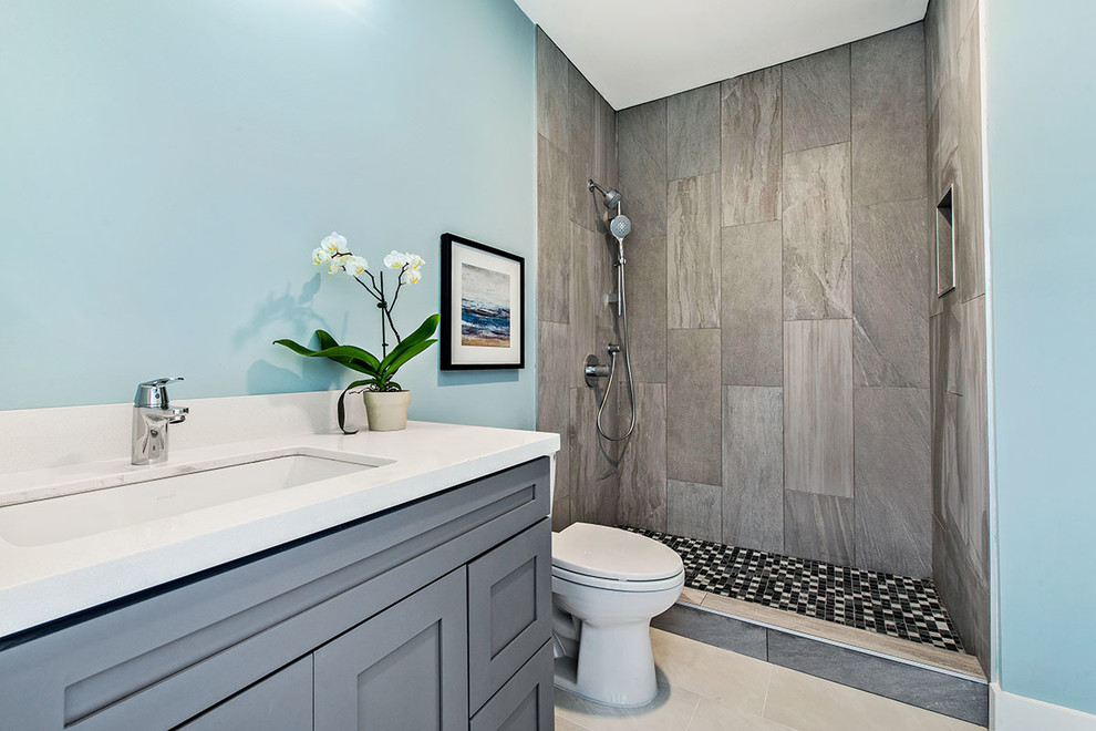 Example of a small transitional master gray tile and porcelain tile porcelain tile doorless shower design in San Francisco with shaker cabinets, a one-piece toilet, blue walls and quartz countertops