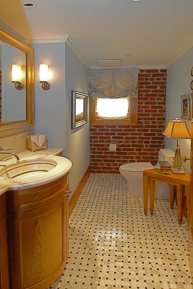 Inspiration for a small timeless 3/4 black and white tile and ceramic tile marble floor bathroom remodel in San Francisco with recessed-panel cabinets, medium tone wood cabinets, a one-piece toilet, blue walls, an undermount sink and marble countertops