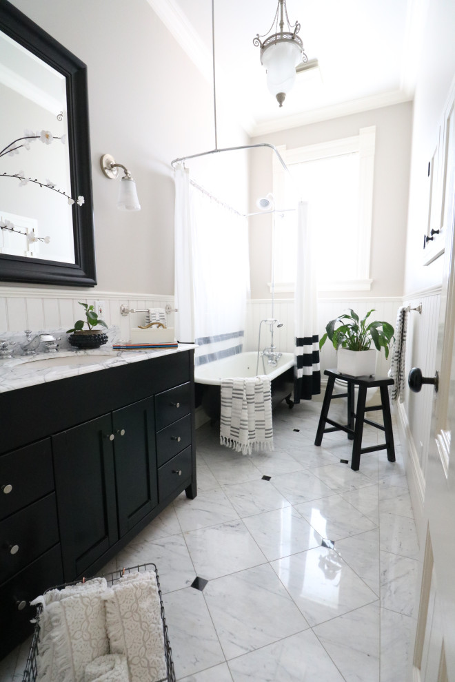 Ornate marble floor and wainscoting claw-foot bathtub photo in San Francisco with marble countertops, white countertops and a freestanding vanity