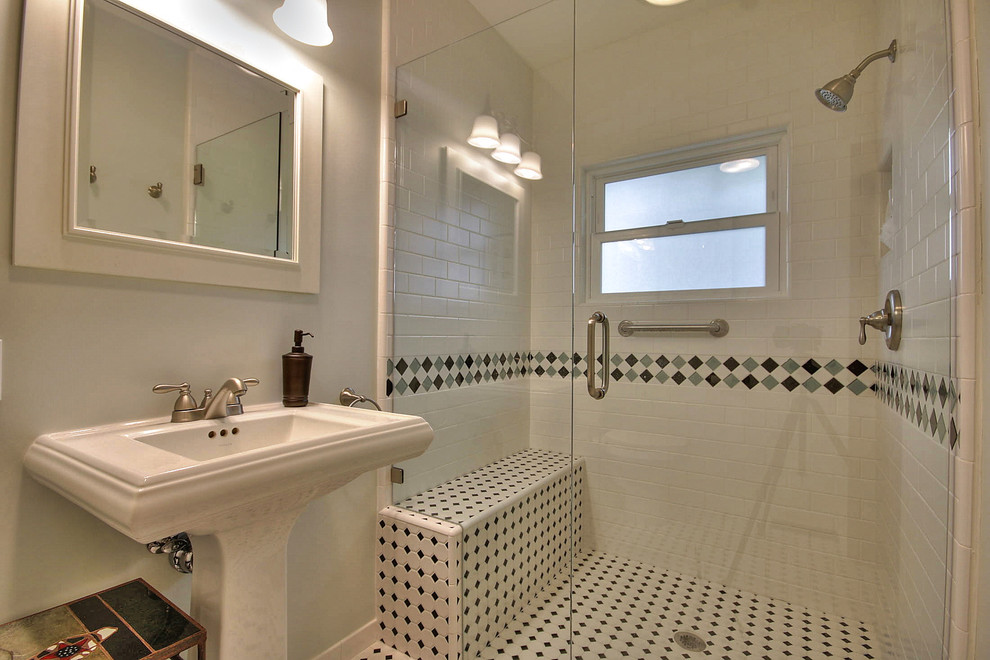 This is an example of a classic shower room bathroom in San Francisco with a pedestal sink, a built-in shower, white tiles, metro tiles, green walls and mosaic tile flooring.