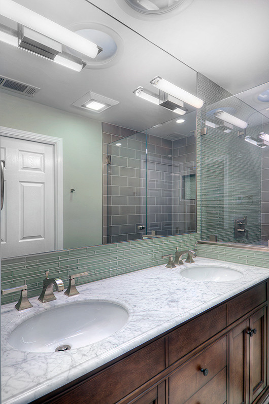 Mid-sized transitional master green tile and glass sheet porcelain tile bathroom photo in San Francisco with an undermount sink, furniture-like cabinets, dark wood cabinets, marble countertops, a one-piece toilet and green walls