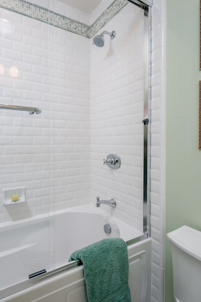 This is an example of a small classic shower room bathroom in San Francisco with beaded cabinets, white cabinets, an alcove bath, a shower/bath combination, white tiles, metro tiles, green walls, porcelain flooring, a submerged sink and engineered stone worktops.