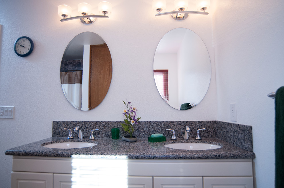 Medium sized classic ensuite bathroom in San Diego with recessed-panel cabinets, medium wood cabinets, a corner bath, an alcove shower, a two-piece toilet, beige tiles, ceramic tiles, white walls, ceramic flooring, a built-in sink and granite worktops.