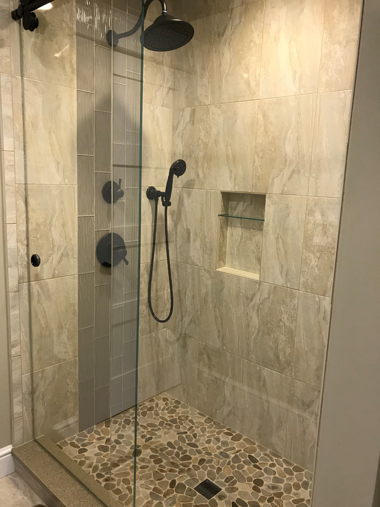 Small elegant 3/4 beige tile and porcelain tile pebble tile floor and brown floor bathroom photo in Bridgeport with beige walls