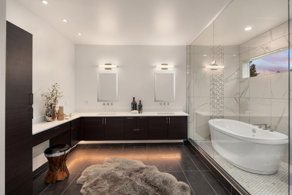 Inspiration for a contemporary ensuite wet room bathroom in Seattle with flat-panel cabinets, dark wood cabinets, a freestanding bath, grey tiles, white tiles, white walls, a submerged sink, grey floors, white worktops, double sinks and a floating vanity unit.