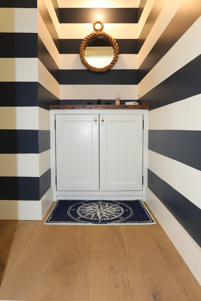 Photo of a small nautical shower room bathroom in Boston with medium hardwood flooring and brown floors.