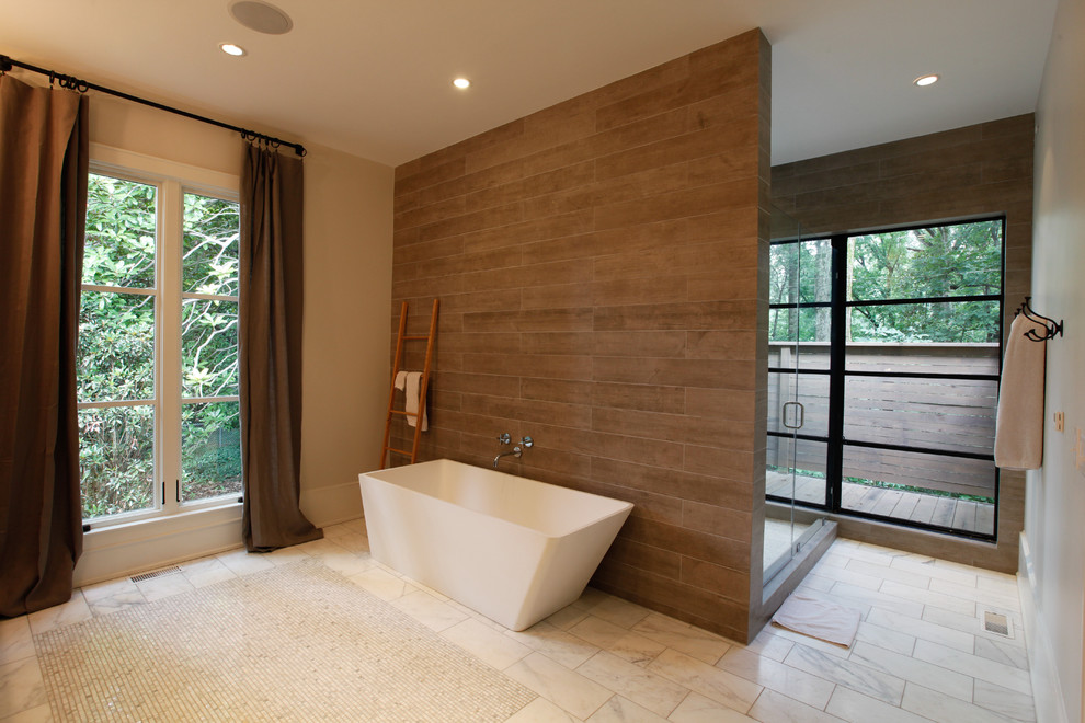 This is an example of a contemporary bathroom in Atlanta with recessed-panel cabinets, medium wood cabinets, a freestanding bath, a walk-in shower, a one-piece toilet, brown tiles and porcelain tiles.