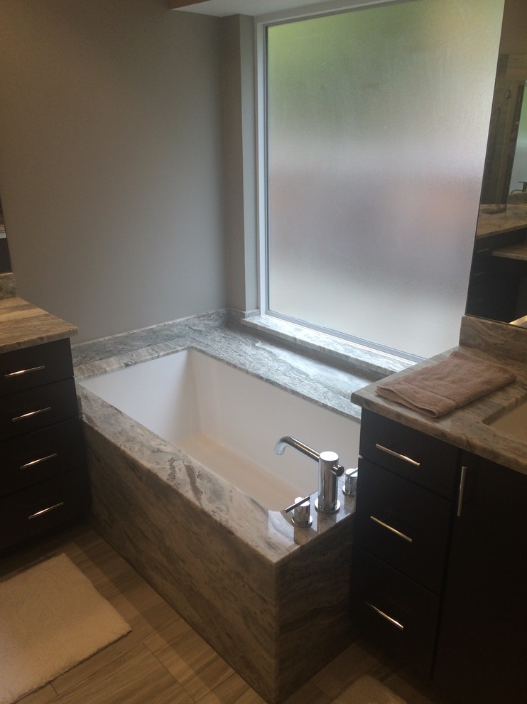 Example of a trendy master white tile and porcelain tile porcelain tile bathroom design in Chicago with marble countertops and an undermount tub