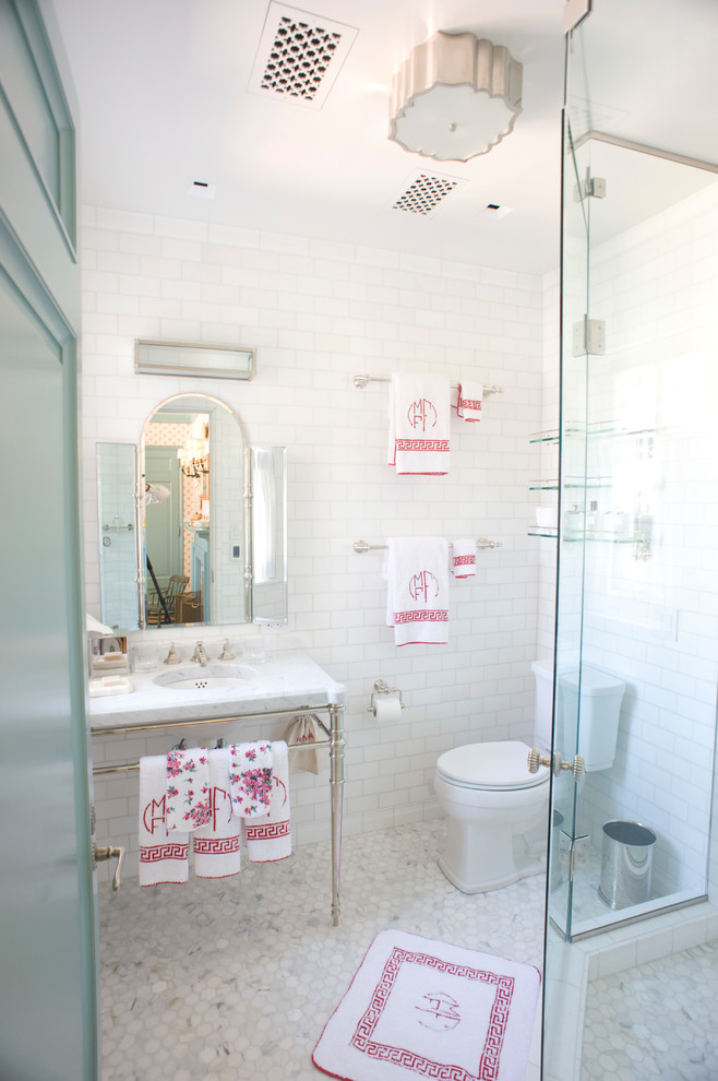 Inspiration for a small coastal 3/4 marble tile porcelain tile and white floor corner shower remodel in Dallas with open cabinets, a two-piece toilet, white walls, an undermount sink, marble countertops and a hinged shower door