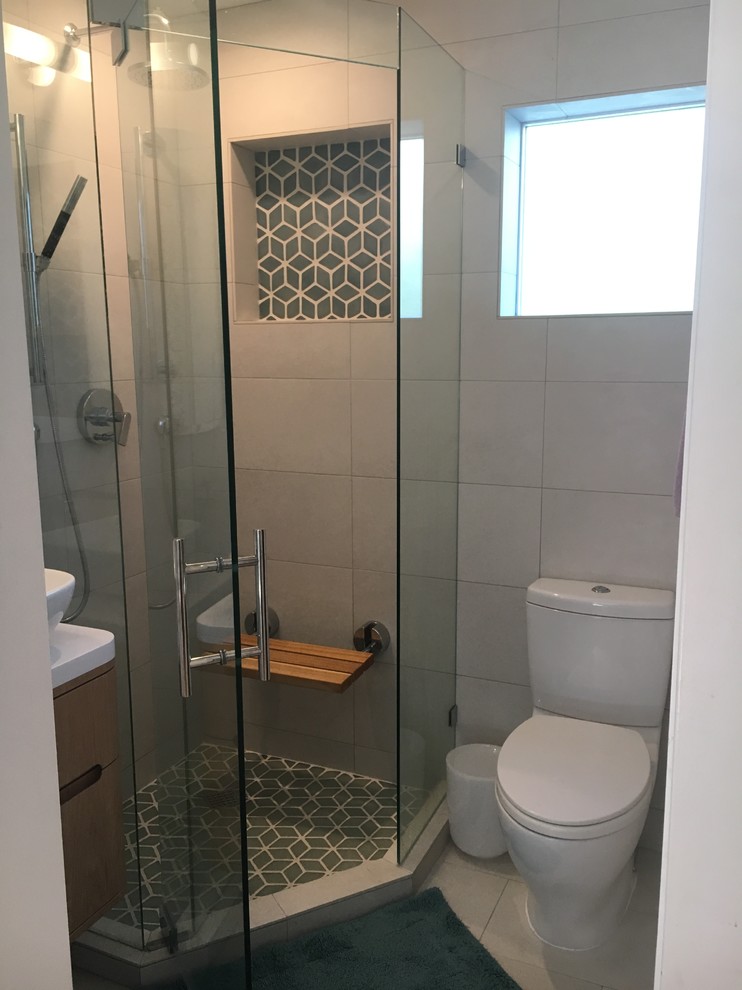 Photo of a small contemporary ensuite bathroom in Santa Barbara with light wood cabinets, a corner shower, white tiles, porcelain tiles, white walls, porcelain flooring, a vessel sink, quartz worktops, white floors, a hinged door and flat-panel cabinets.