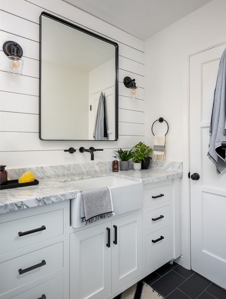 This is an example of a small rural shower room bathroom in Los Angeles with shaker cabinets, white cabinets, an alcove shower, a one-piece toilet, white tiles, porcelain tiles, white walls, porcelain flooring, a trough sink, marble worktops, grey floors, a sliding door and grey worktops.